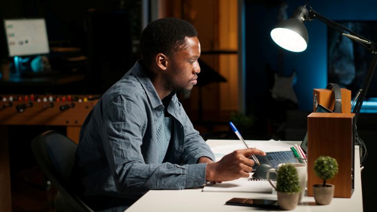 A man thinking intently about what to write.