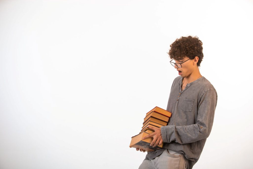A man carrying a lot of books.