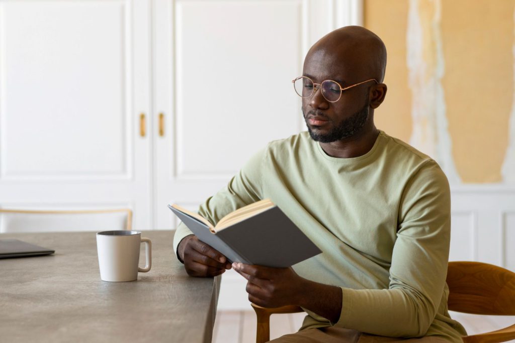 A man reading a book about someone else’s life.