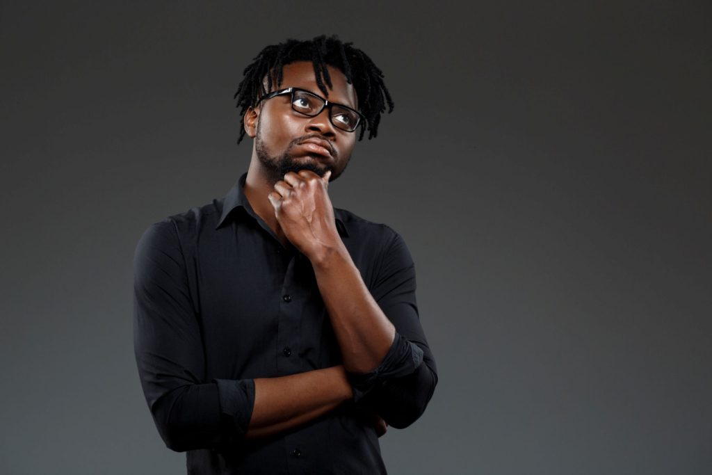 A man thinking about how to slow down his writing.